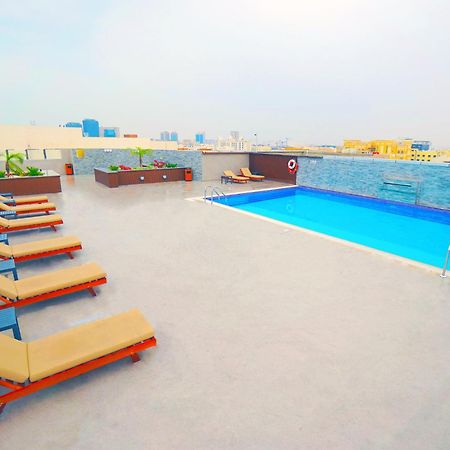 The Grand Lux Hotel Doha Exterior photo Rooftop pool at the hotel