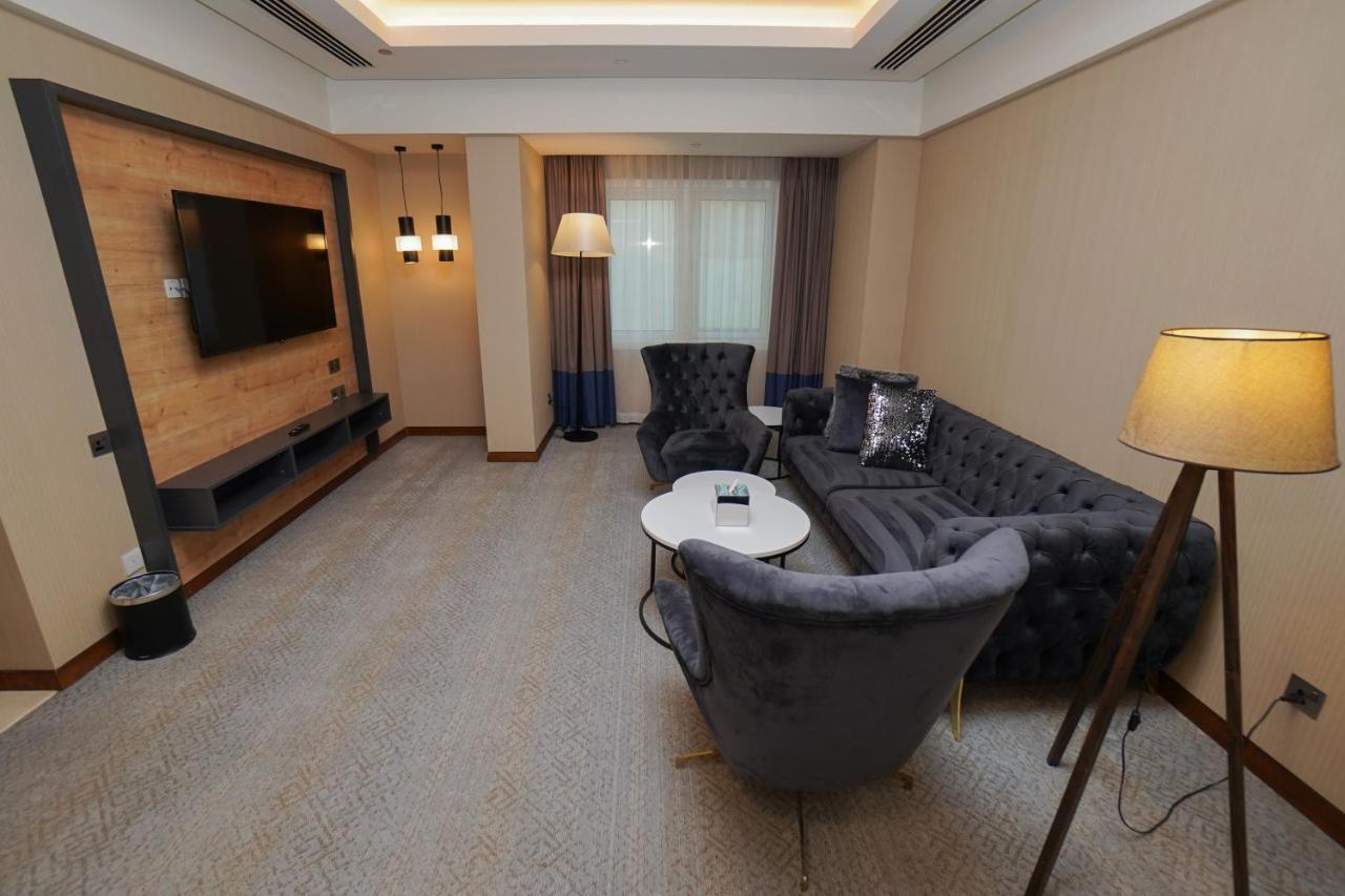 The Grand Lux Hotel Doha Exterior photo A living room in a hotel suite